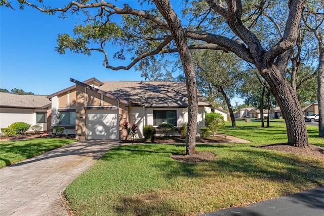 view of front of house with a front lawn and a garage