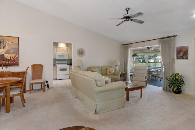 living room featuring ceiling fan, light colored carpet, and vaulted ceiling