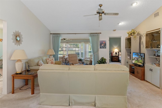 carpeted living room featuring ceiling fan, lofted ceiling, and a textured ceiling