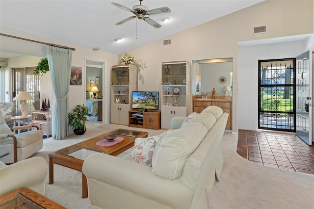 carpeted living room with ceiling fan and lofted ceiling