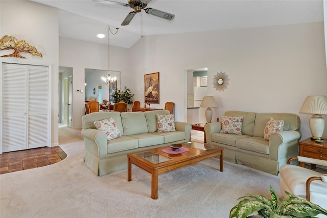 carpeted living room with high vaulted ceiling and ceiling fan with notable chandelier