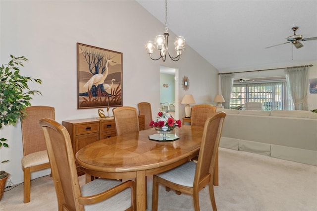 dining space featuring light carpet, ceiling fan with notable chandelier, and lofted ceiling