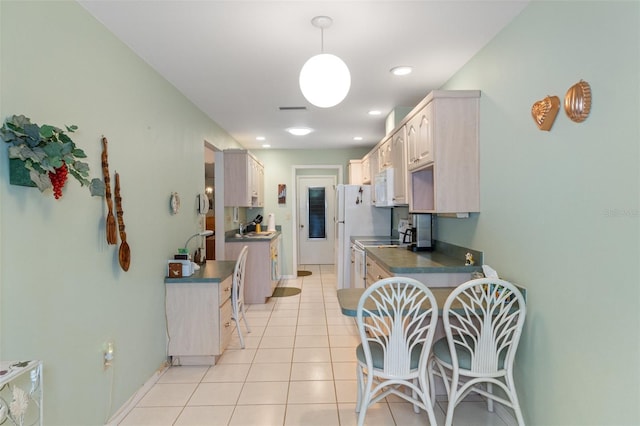 kitchen featuring pendant lighting, stainless steel range oven, and light tile patterned floors