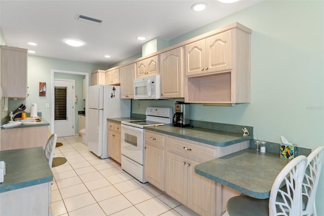 kitchen with light tile patterned flooring, white appliances, sink, and light brown cabinets