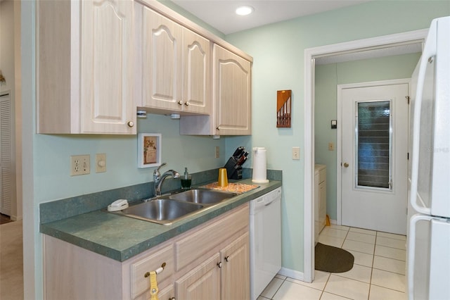 kitchen featuring light brown cabinets, light tile patterned flooring, white appliances, and sink