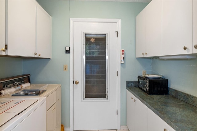 clothes washing area with washer and dryer and cabinets