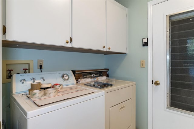 washroom featuring separate washer and dryer and cabinets