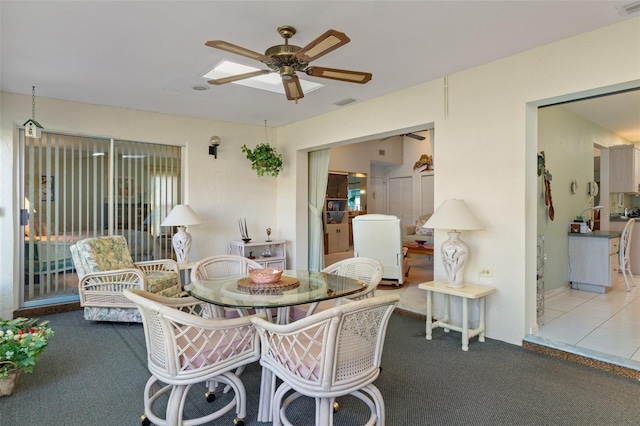 dining area featuring ceiling fan and carpet floors