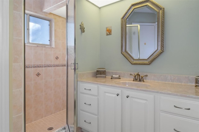 bathroom with vanity and a shower with shower door