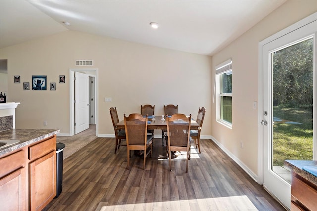 dining space featuring dark hardwood / wood-style flooring and lofted ceiling