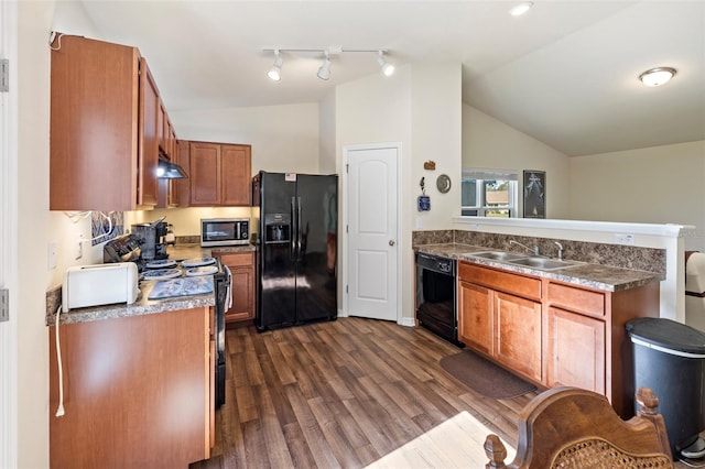 kitchen with black appliances, lofted ceiling, sink, and dark wood-type flooring