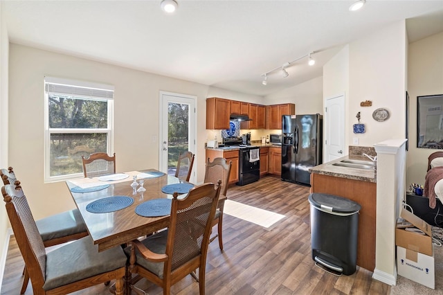 dining area with hardwood / wood-style flooring and sink