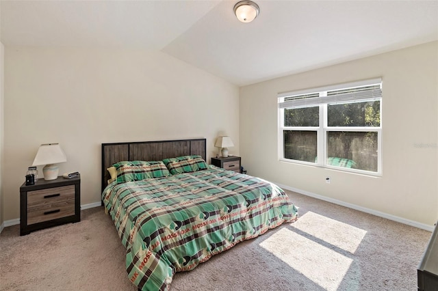 carpeted bedroom featuring lofted ceiling