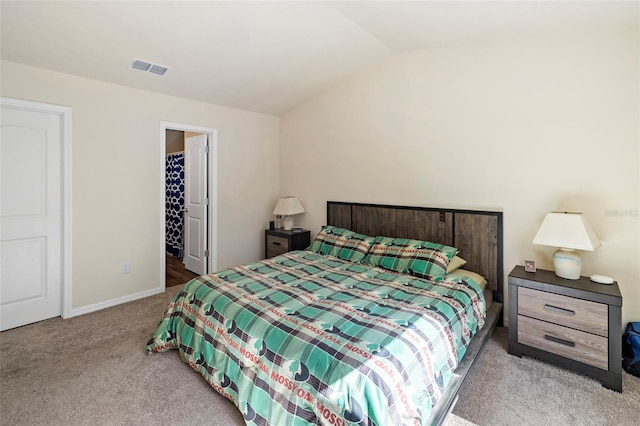 bedroom with carpet flooring and lofted ceiling