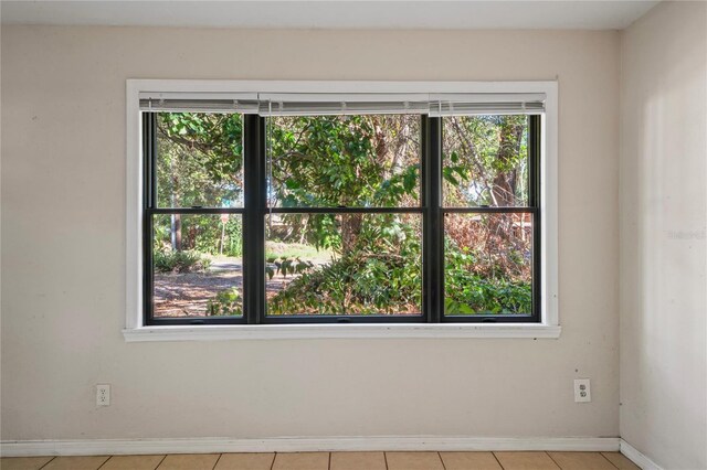 unfurnished room featuring light tile patterned floors