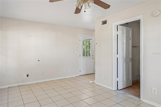 empty room featuring ceiling fan and light tile patterned floors