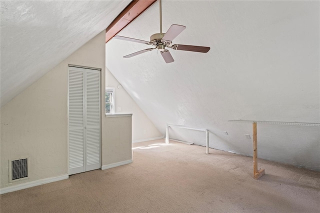 bonus room with a textured ceiling, ceiling fan, carpet, and vaulted ceiling