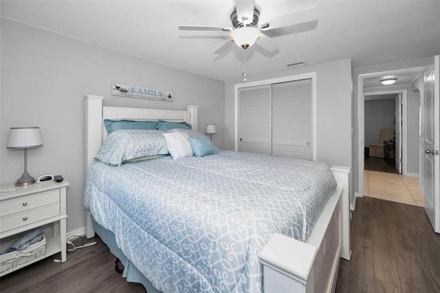 bedroom with dark hardwood / wood-style floors, ceiling fan, and a closet