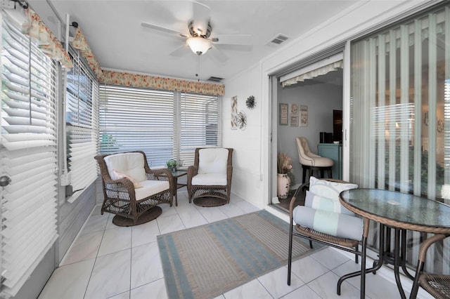 sunroom featuring ceiling fan