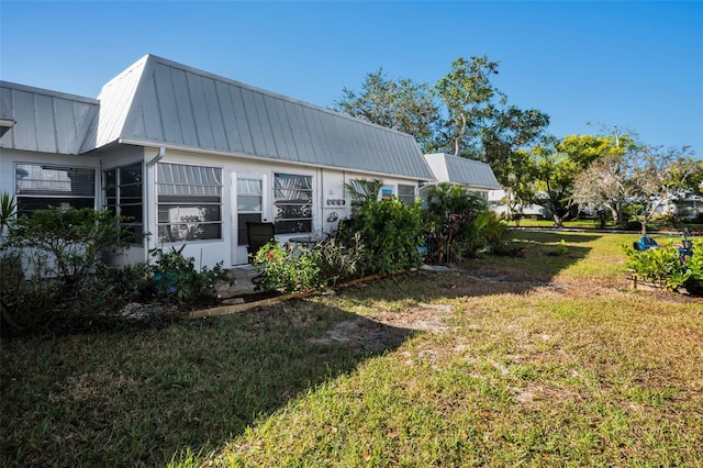 view of home's exterior with a yard