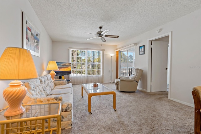 living room with carpet flooring, a textured ceiling, and ceiling fan