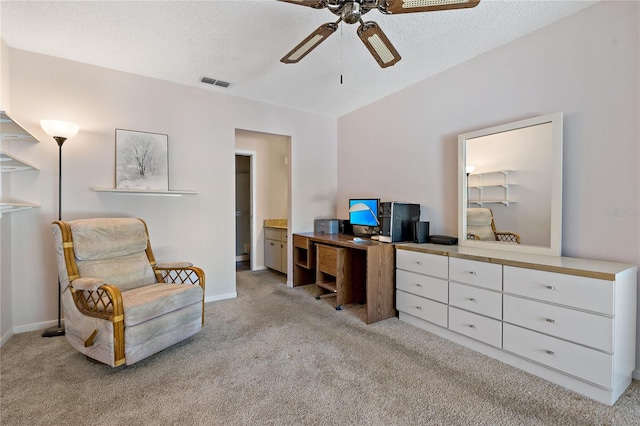 office space featuring ceiling fan, light colored carpet, and a textured ceiling