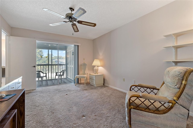 living area with carpet, a textured ceiling, and ceiling fan