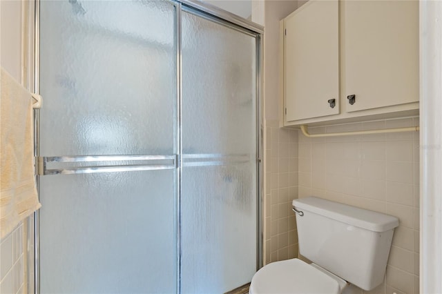 bathroom with walk in shower, tile walls, and toilet