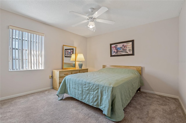 bedroom with carpet flooring, ceiling fan, and a textured ceiling