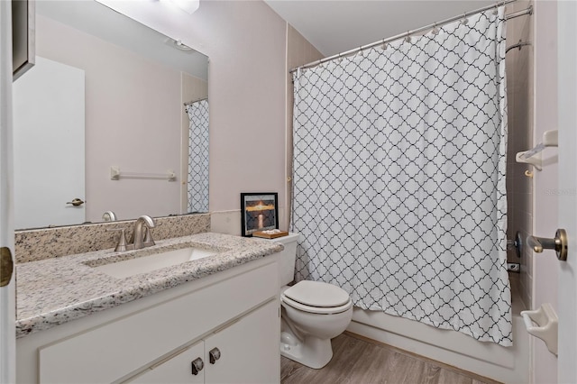 full bathroom with hardwood / wood-style floors, vanity, shower / bath combination with curtain, and toilet