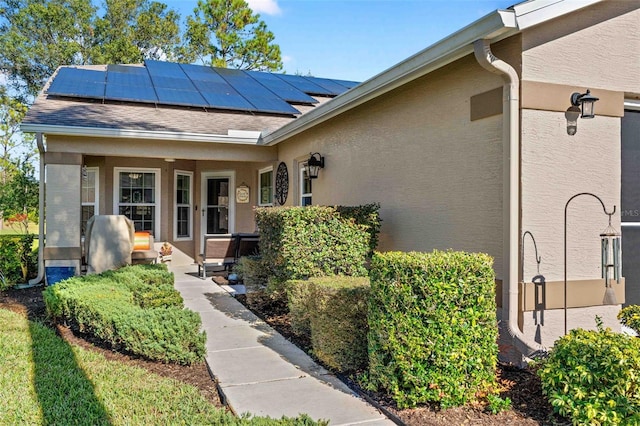 doorway to property featuring solar panels