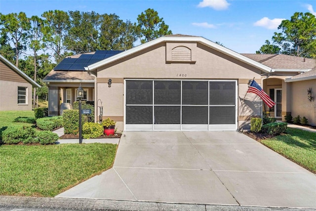 view of front of property with a front yard and solar panels