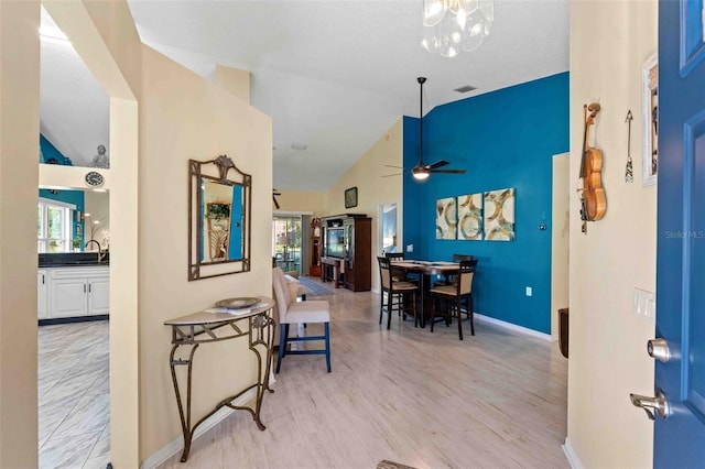 interior space with light hardwood / wood-style floors, high vaulted ceiling, ceiling fan, and sink