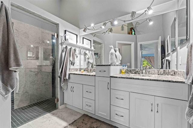 bathroom featuring a tile shower and vanity