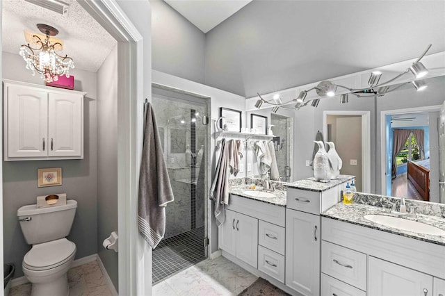 bathroom featuring a textured ceiling, vanity, tiled shower, a notable chandelier, and toilet