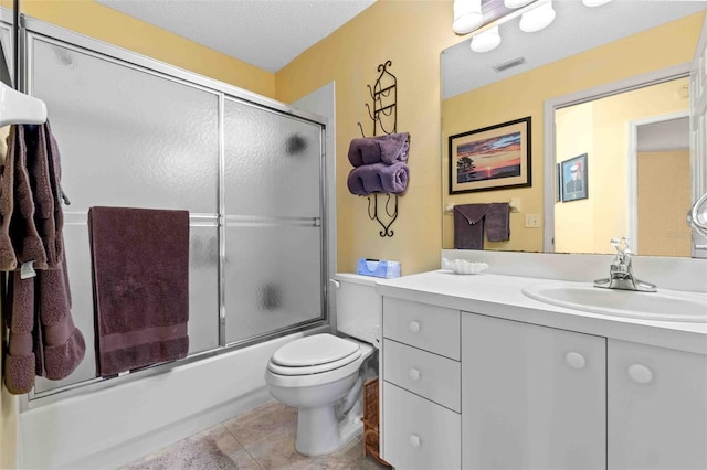 full bathroom featuring tile patterned flooring, enclosed tub / shower combo, a textured ceiling, toilet, and vanity