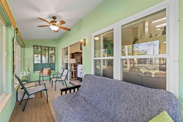 sunroom featuring ceiling fan and lofted ceiling