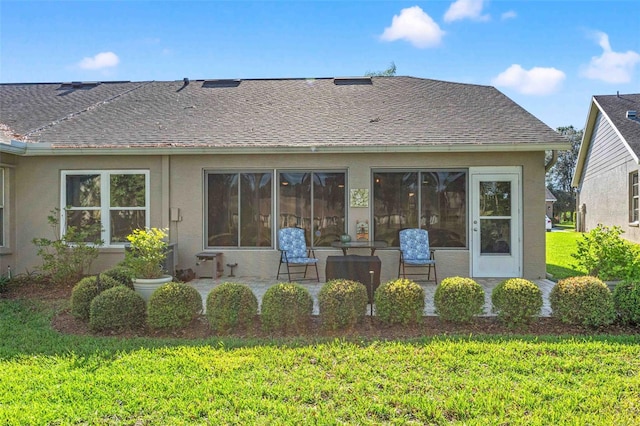 back of property featuring a lawn and a patio