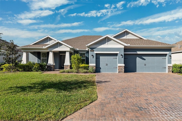 craftsman-style home with a front yard and a garage