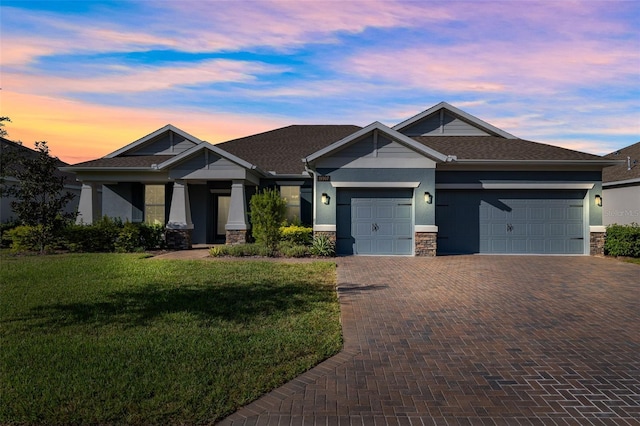 craftsman inspired home featuring a yard and a garage