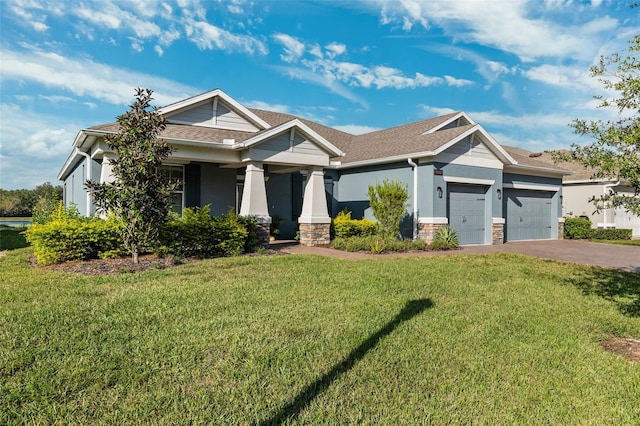 craftsman-style house featuring a garage and a front lawn