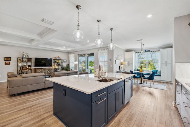 kitchen featuring coffered ceiling, a healthy amount of sunlight, a kitchen island with sink, and light hardwood / wood-style flooring