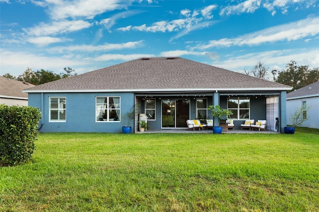 rear view of property featuring an outdoor living space, a yard, and a patio