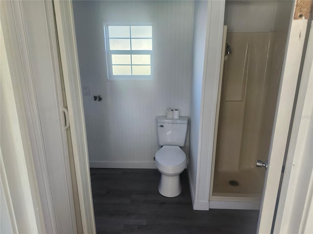 bathroom featuring walk in shower, wood-type flooring, and toilet