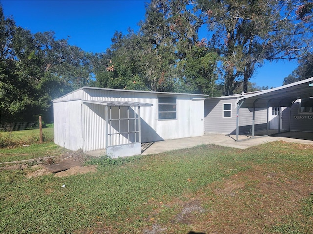 exterior space with a carport and a front yard