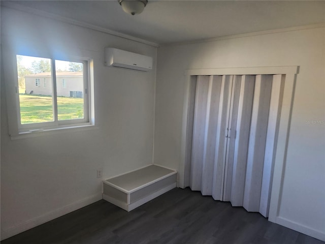 interior space featuring dark hardwood / wood-style floors, an AC wall unit, and crown molding