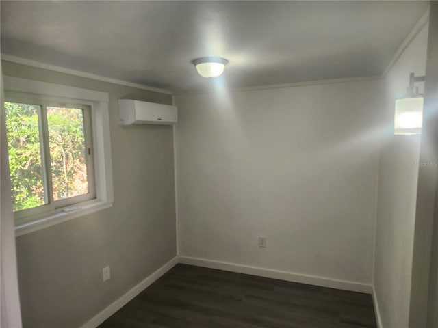 spare room featuring a wall mounted AC, crown molding, and dark hardwood / wood-style flooring