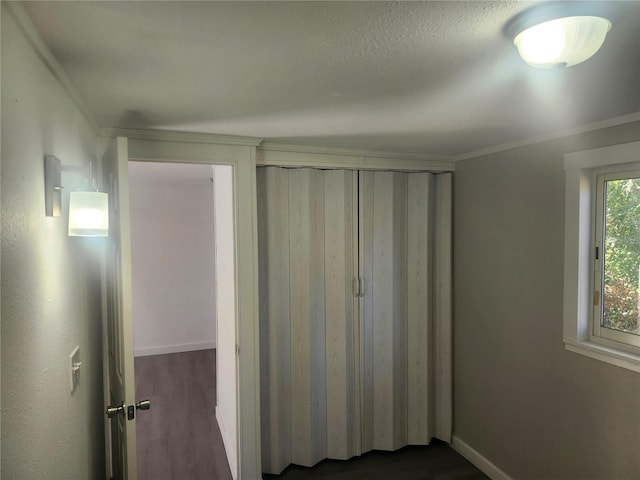 unfurnished bedroom featuring dark hardwood / wood-style floors and crown molding