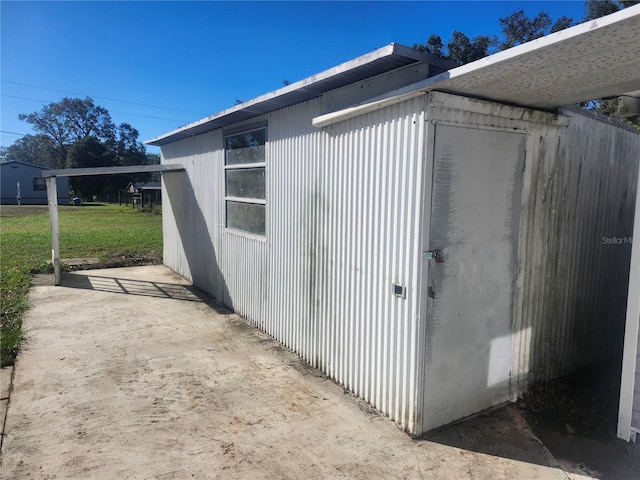 view of outbuilding with a yard