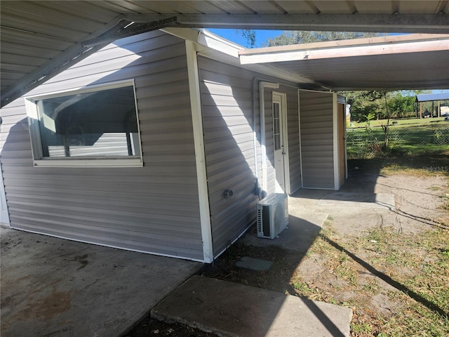 view of home's exterior with ac unit and a carport